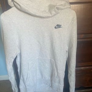 Has a big hoodie, turtle neck.